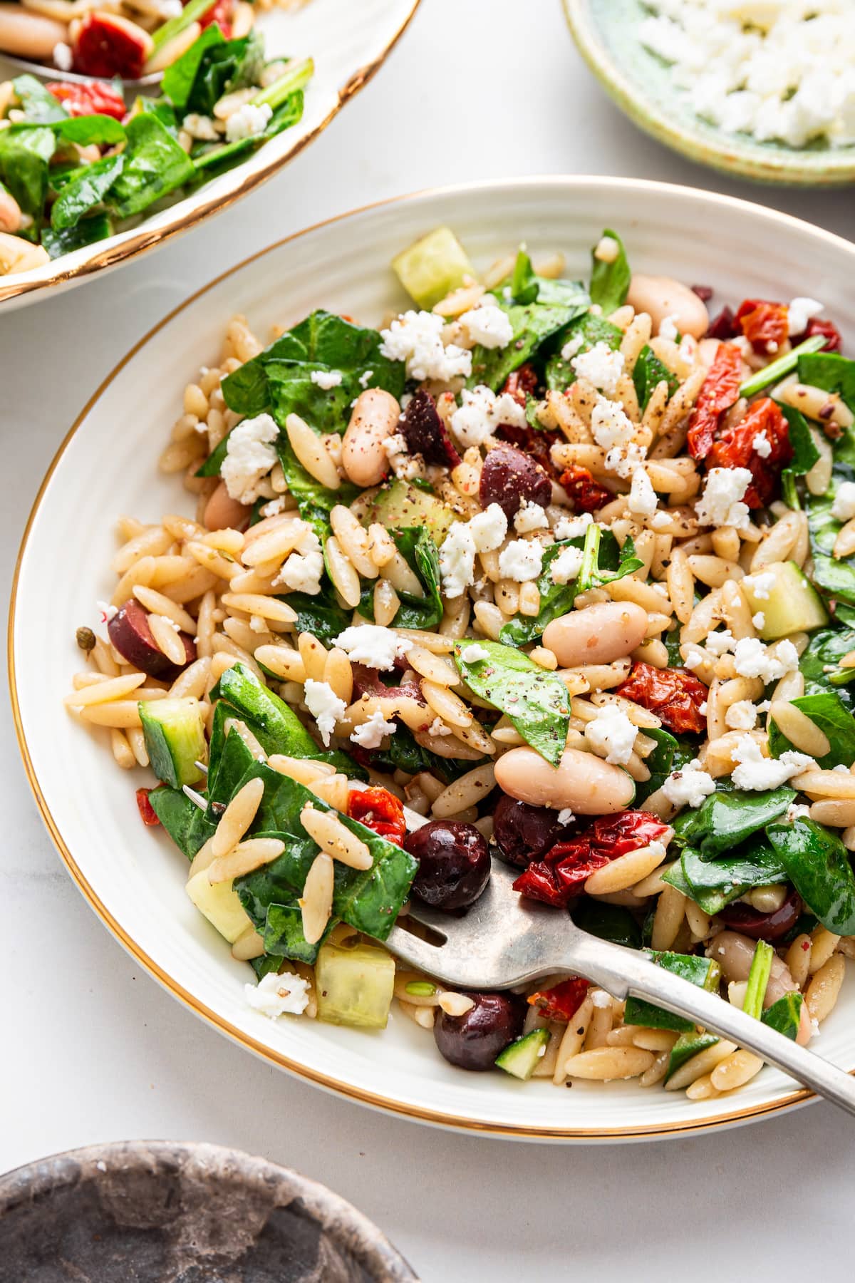 A serving of Mediterranean orzo salad on a plate.