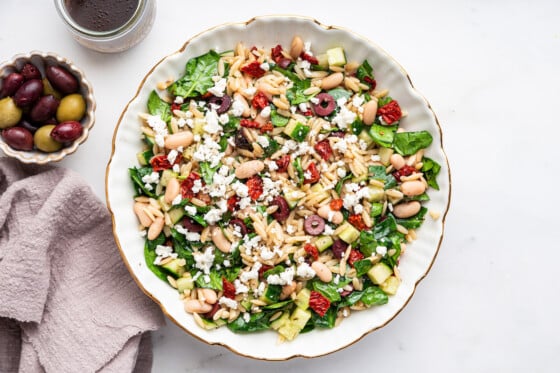 A large bowl of mediterranean orzo salad.