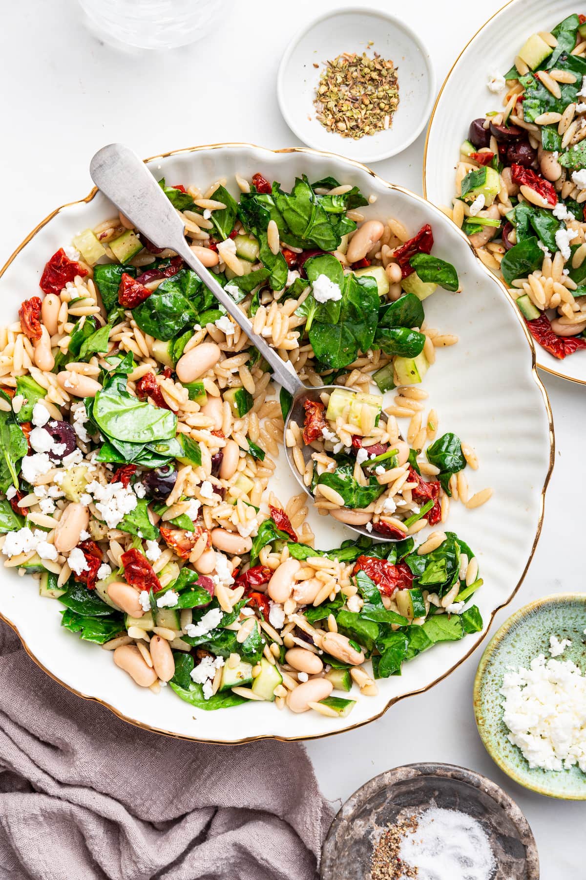 A large bowl of mediterranean orzo salad.