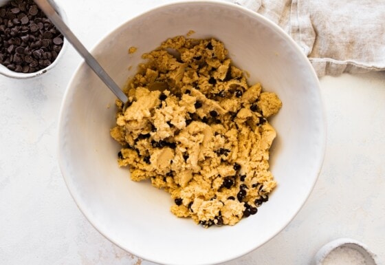 The protein cookie dough bark dough with chocolate chips mixed together in a bowl.