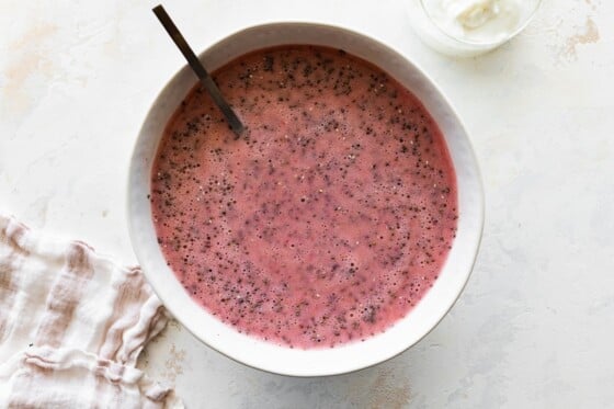 Blended strawberries, milk, and chia seeds in a bowl.