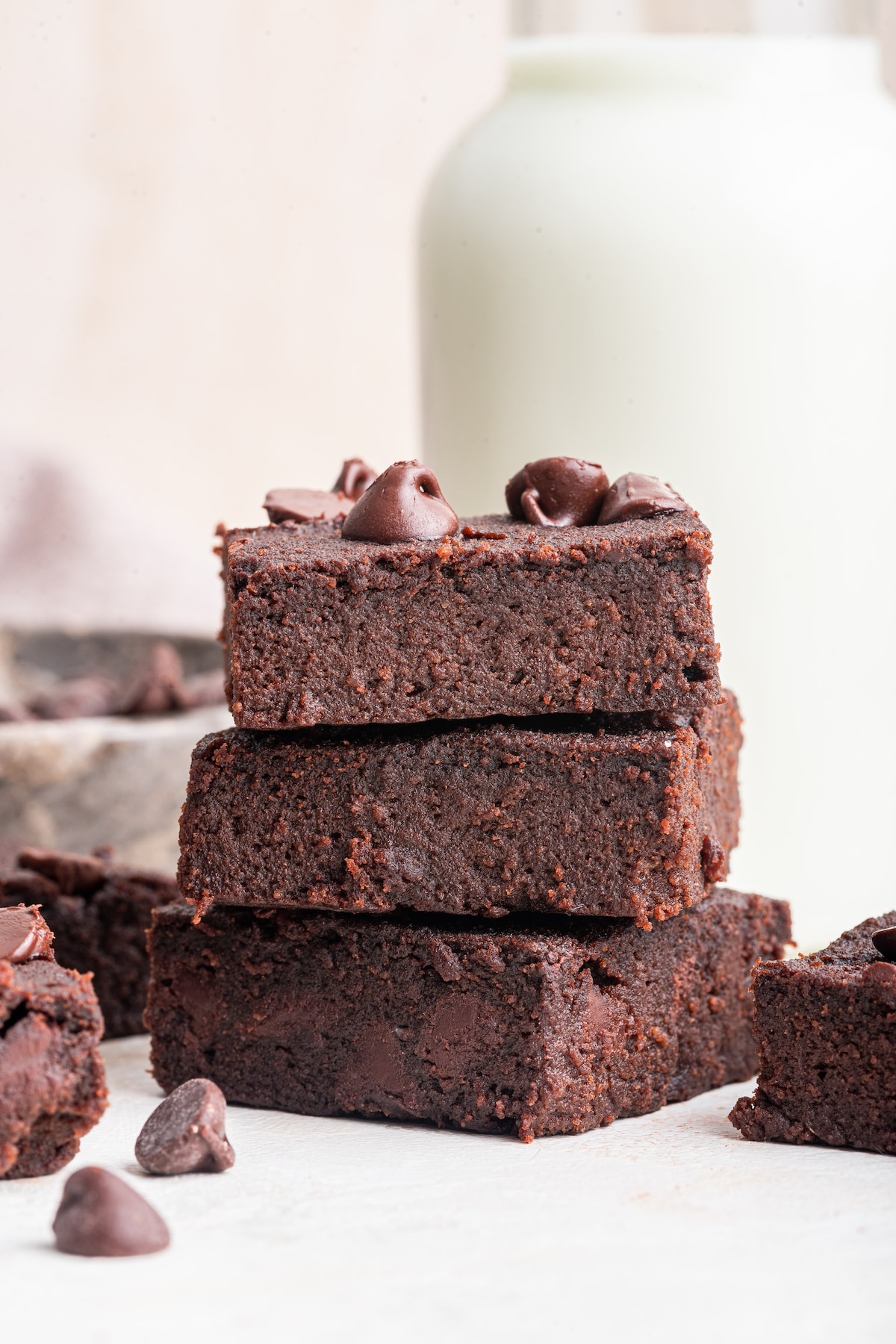 Three chocolate chip sweet potato brownies stacked on one another.