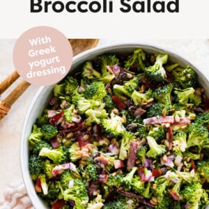 Classic Broccoli Salad in a serving bowl with wood salad spoons next to it.