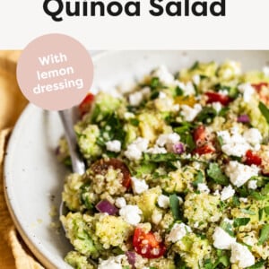 Quinoa salad in a bowl with a spoon.