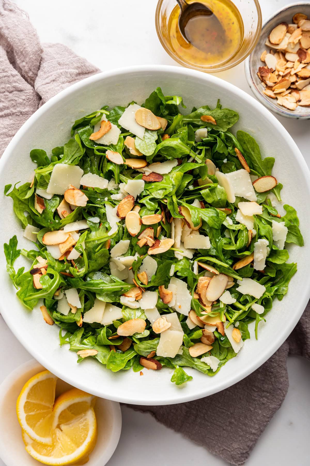 Arugula salad served in a white bowl.