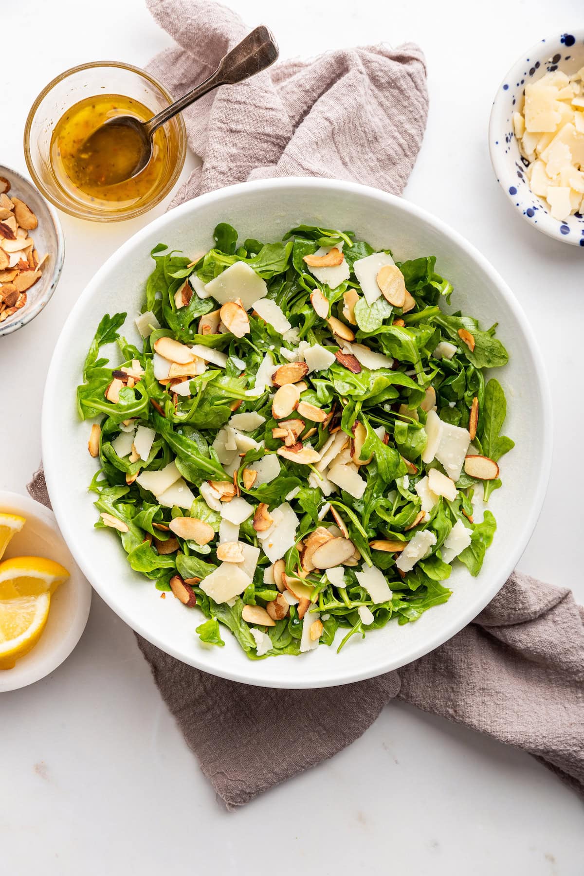 Arugula salad served in a white bowl.