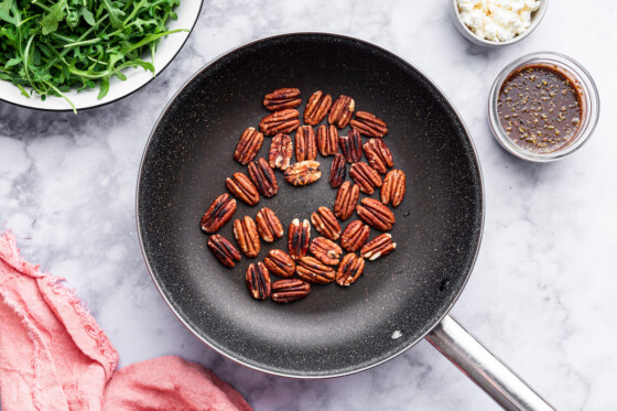 Toasted pecans in a pan.