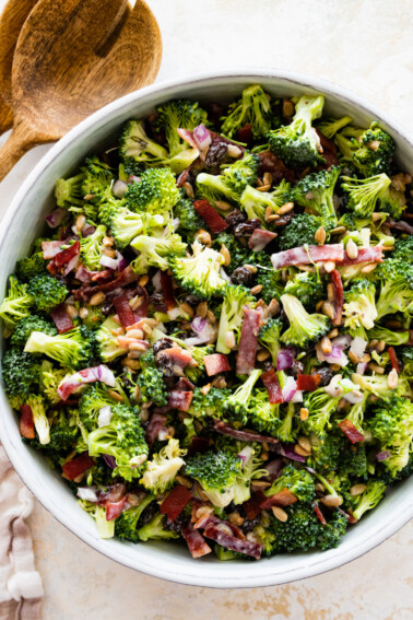 A broccoli salad in a large white bowl.