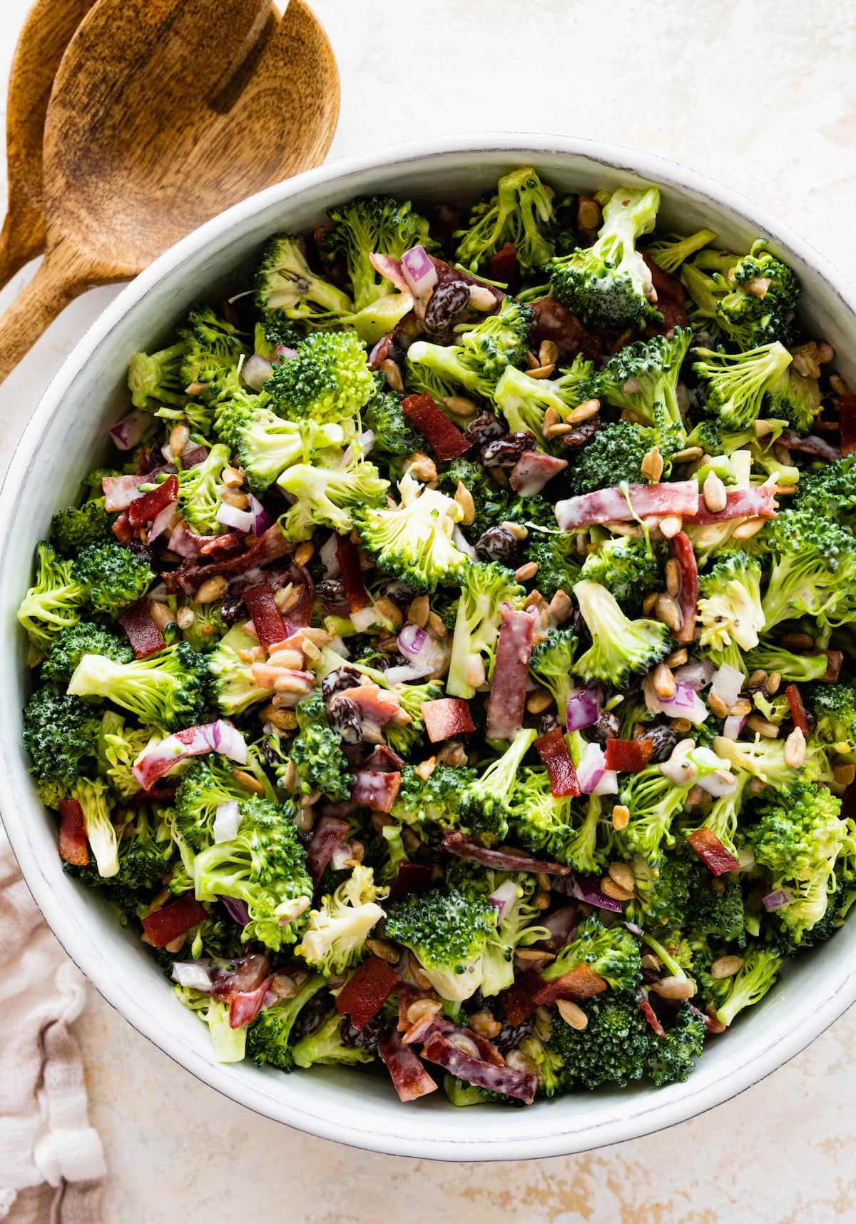 A broccoli salad in a large white bowl.