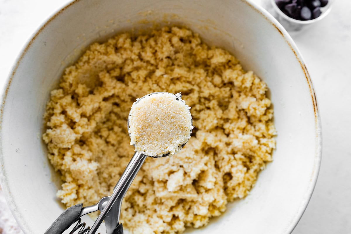 A cookie scoop with coconut macaroon dough.
