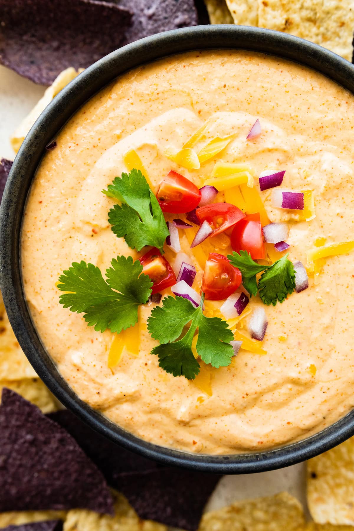 Cottage cheese queso in a small bowl with tortilla chips.