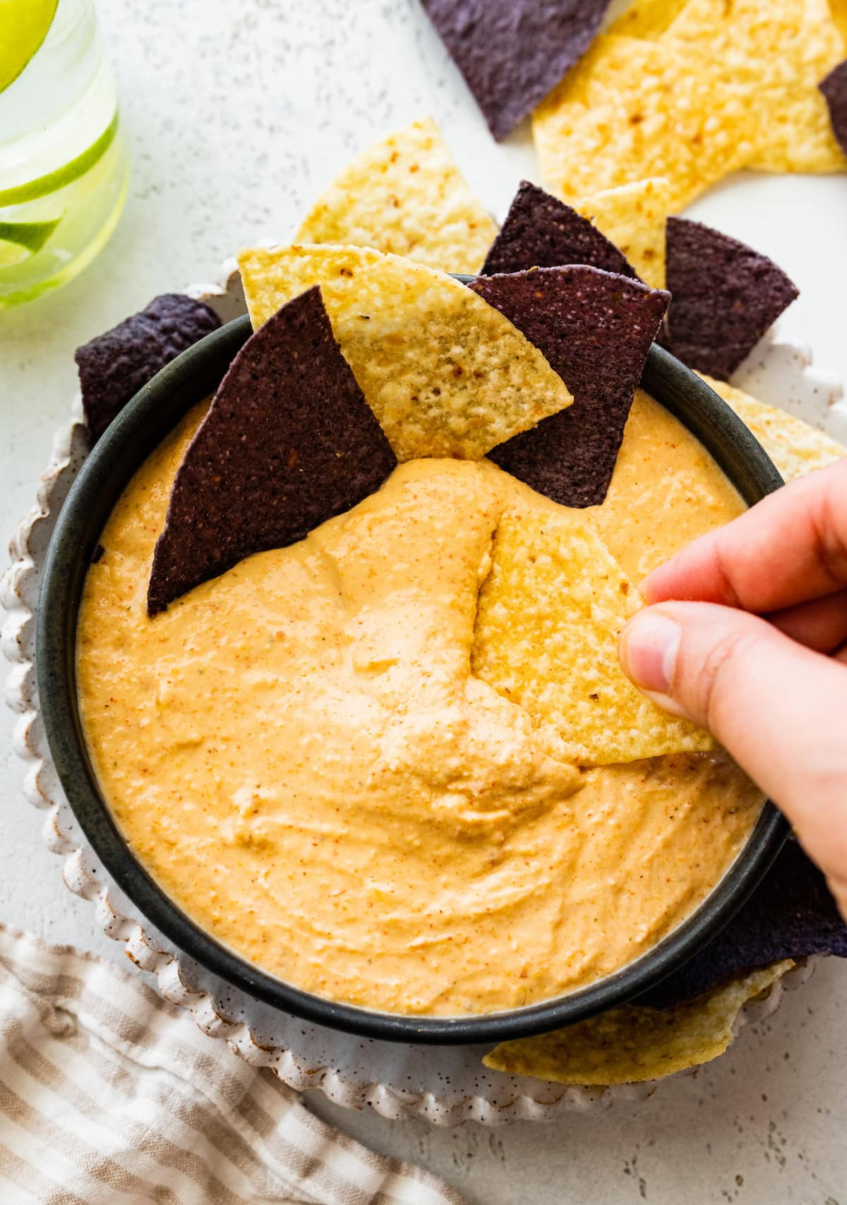 Cottage cheese queso in a small bowl with tortilla chips.