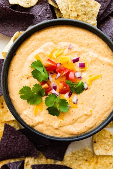 Cottage cheese queso in a small bowl with tortilla chips.