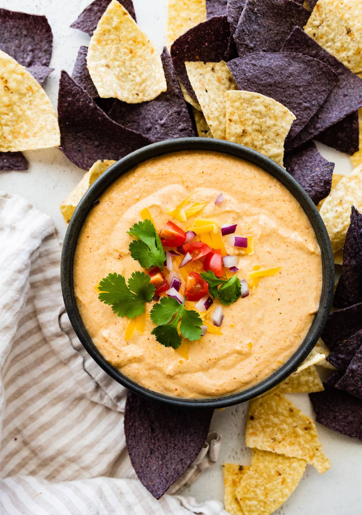 Cottage cheese queso in a small bowl with tortilla chips.