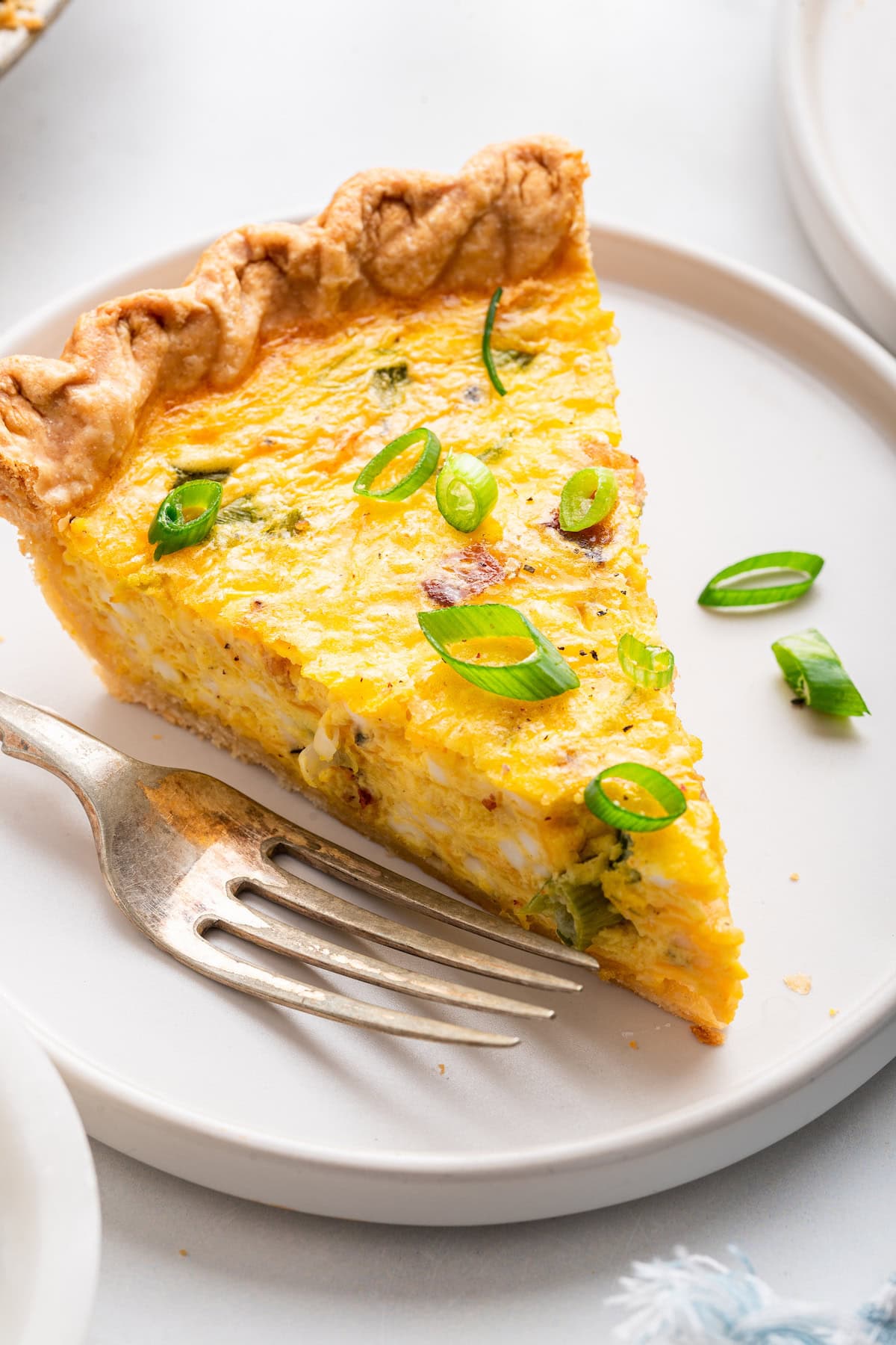 A slice of cottage cheese quiche on a plate.