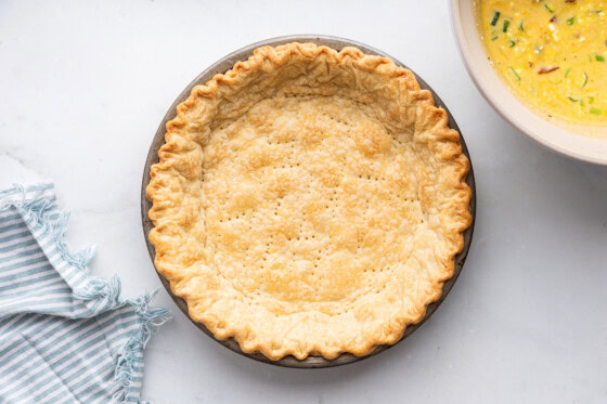 Pie crust in a pan used for a cottage cheese quiche.