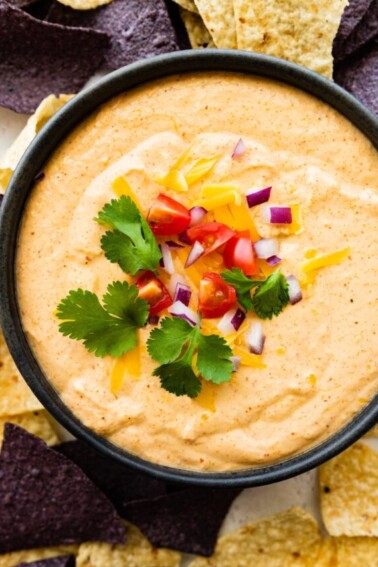 Cottage cheese queso in a small bowl with tortilla chips.