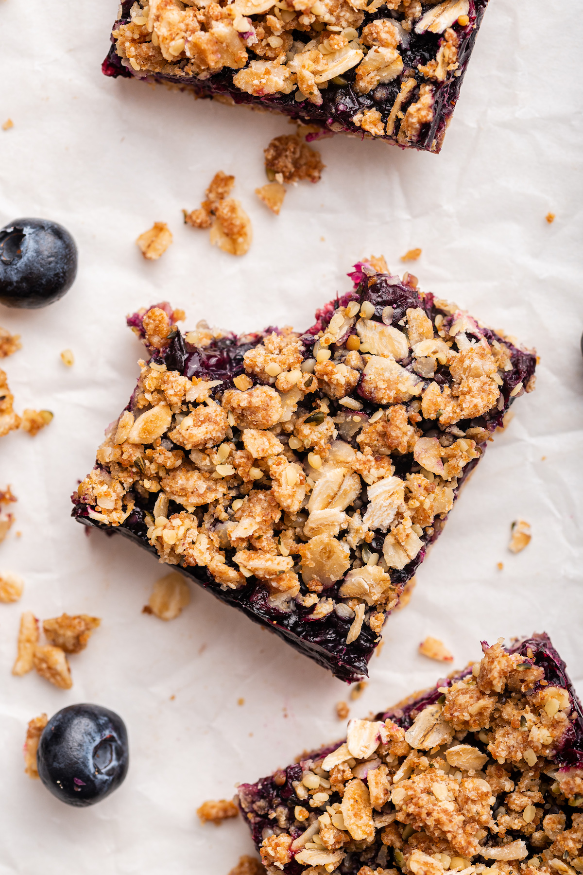 A blueberry crumble bar with a bite taken from it.