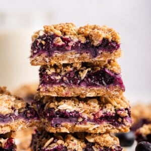Blueberry crumble bars stacked on one another.