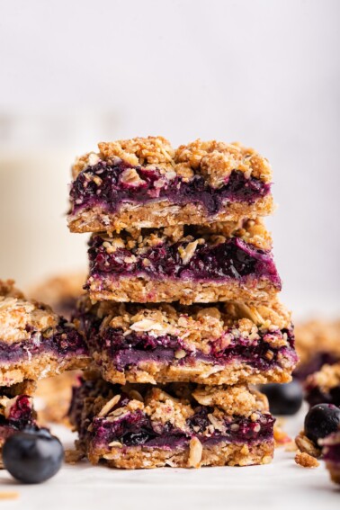 Blueberry crumble bars stacked on one another.