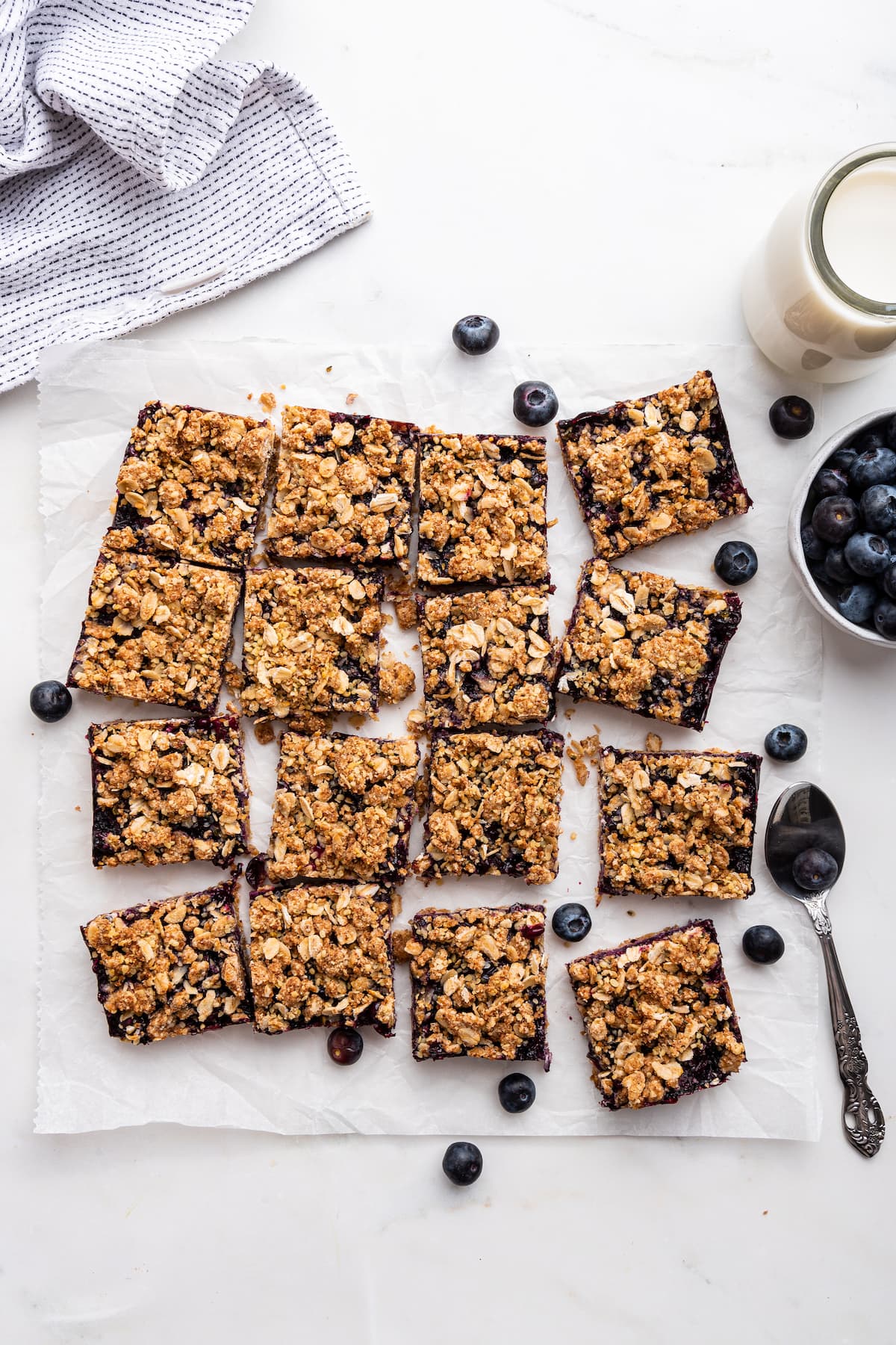 Healthy blueberry crumble bars on parchment paper.