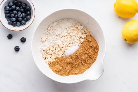 Dry ingredients for blueberry crumble bars in a mixing bowl.