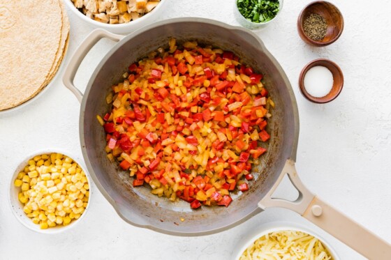 Cooked onion and tomato in a large skillet.