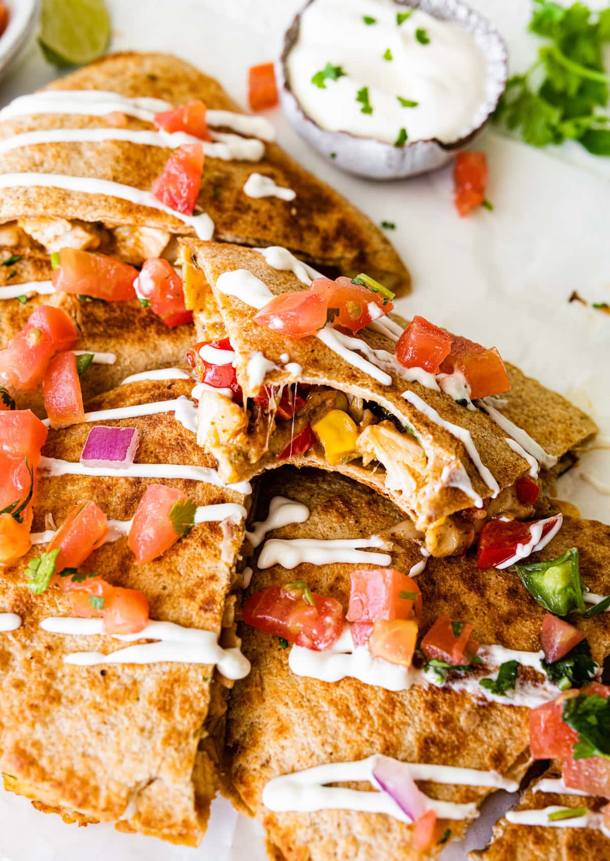 Healthy chicken quesadilla with a drizzle of sour cream.