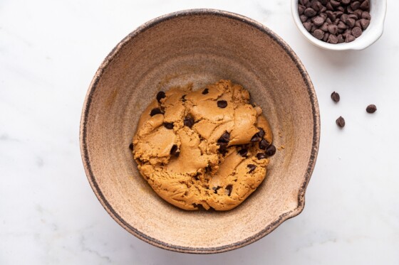 Dough for the protein bars in a mixing bowl with chocolate chips.