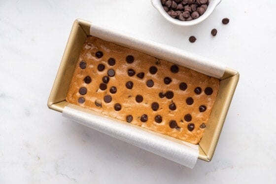 Protein bar mixture in a loaf pan before being cut into 6 bars.