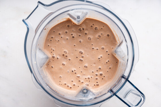 Ingredients used for a samoa cookie protein shake in a blender after being blended.