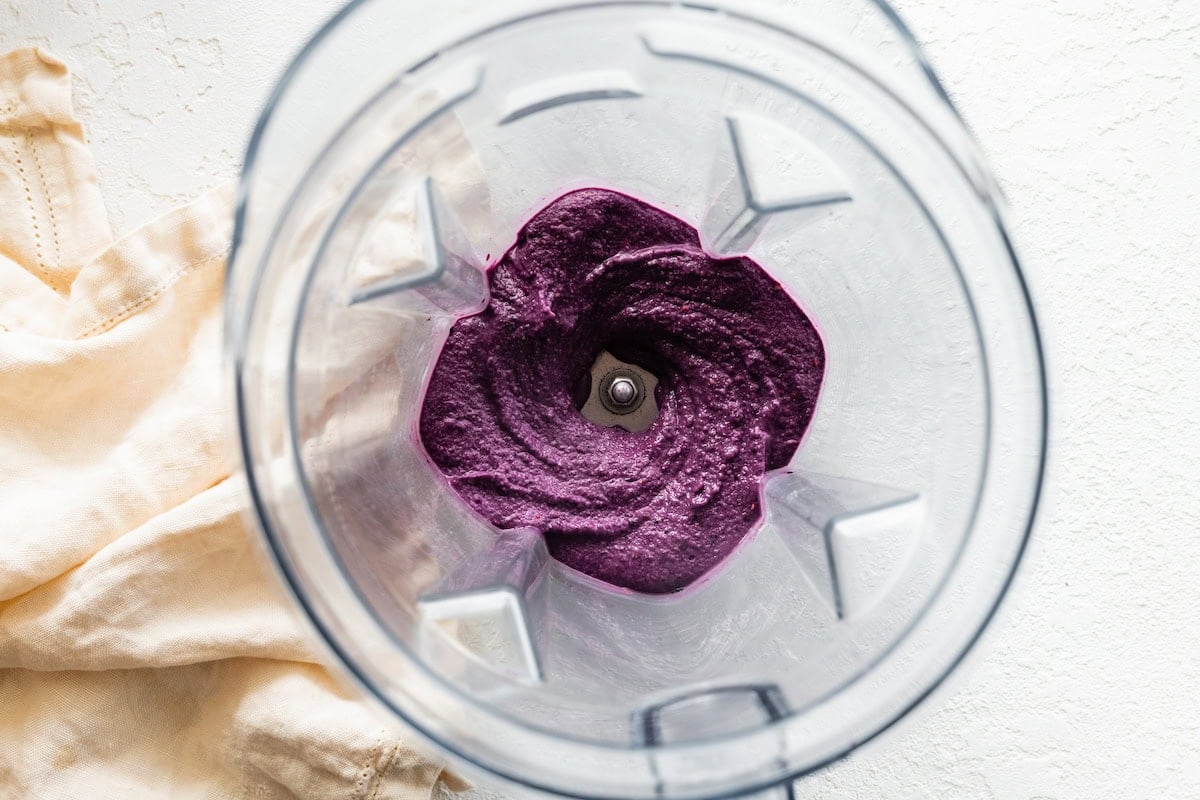 A blended berry smoothie in a blender.