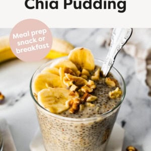 Photo of Banana Chia Pudding in a jar topped with walnuts and banana slices. A spoon is in the jar.
