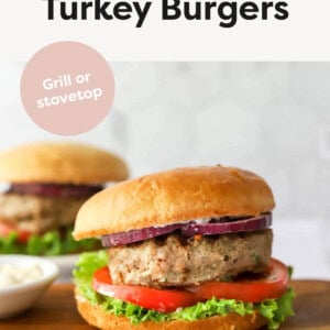 Turkey burger with onion, lettuce and tomato on a bun.
