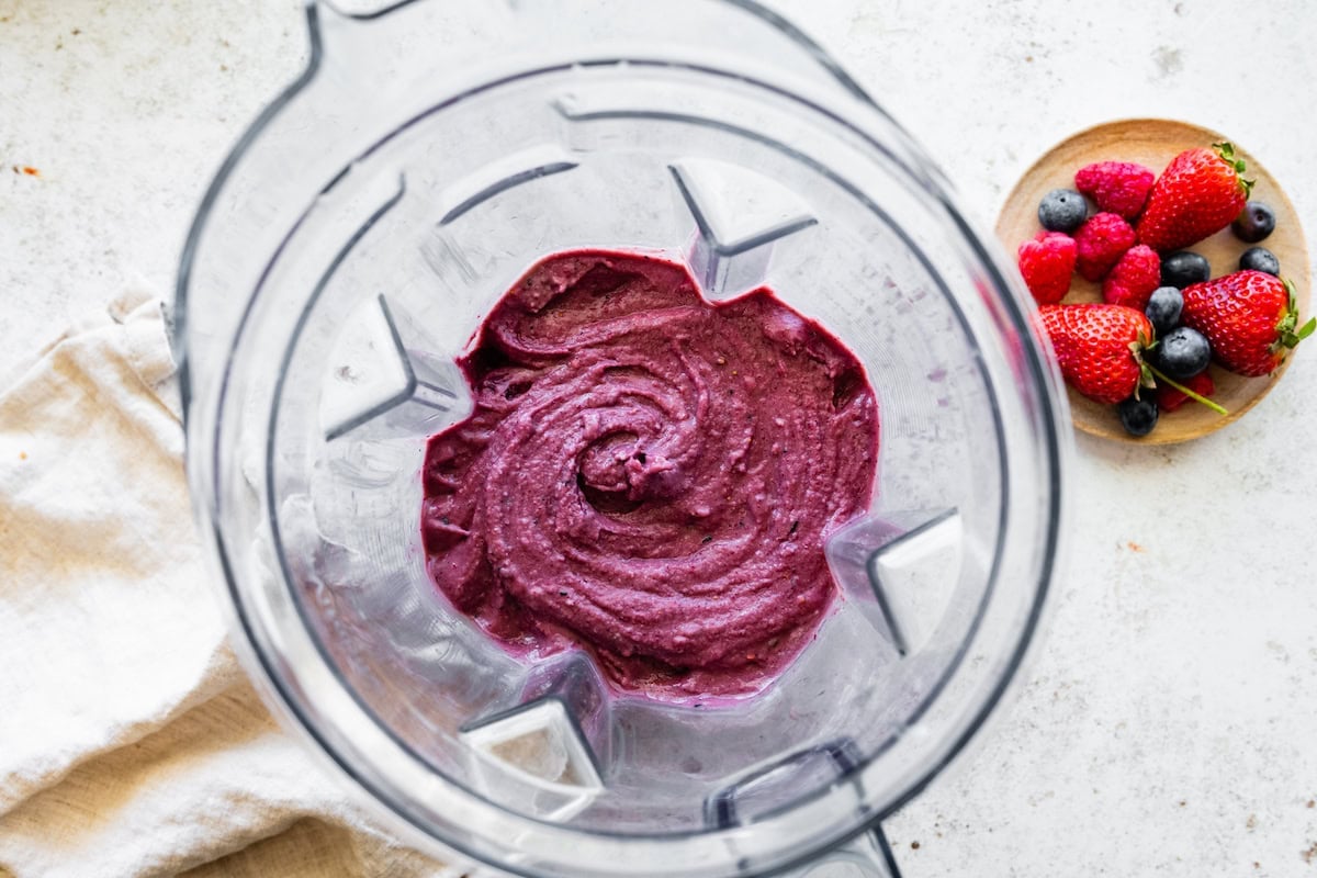 A protein acai smoothie blended in a blender.