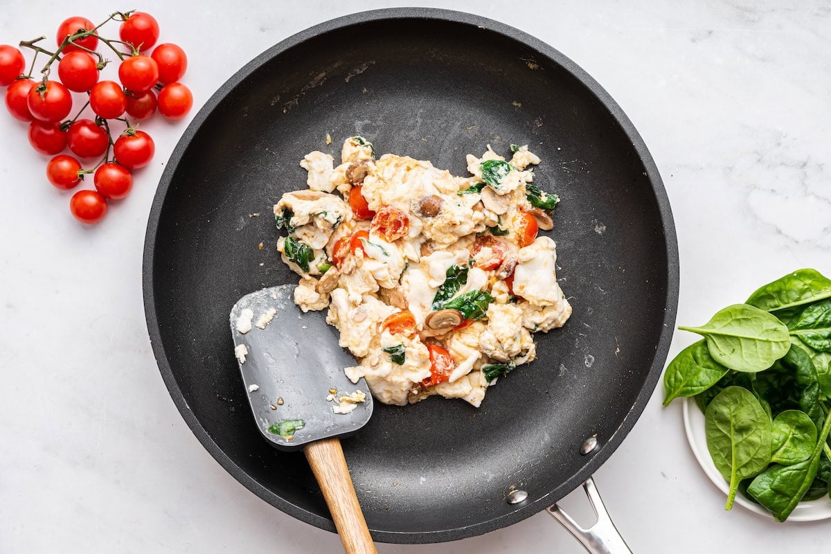 Scrambled egg whites in a skillet with a silicone spatula.