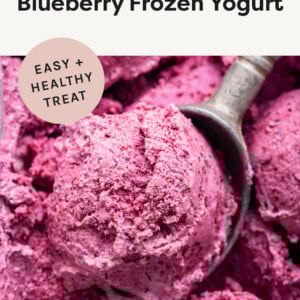 Ice cream scooper taking a scoop of 3-Ingredient Blueberry Frozen Yogurt.