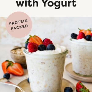 Jar of yogurt overnight oats topped with berries.