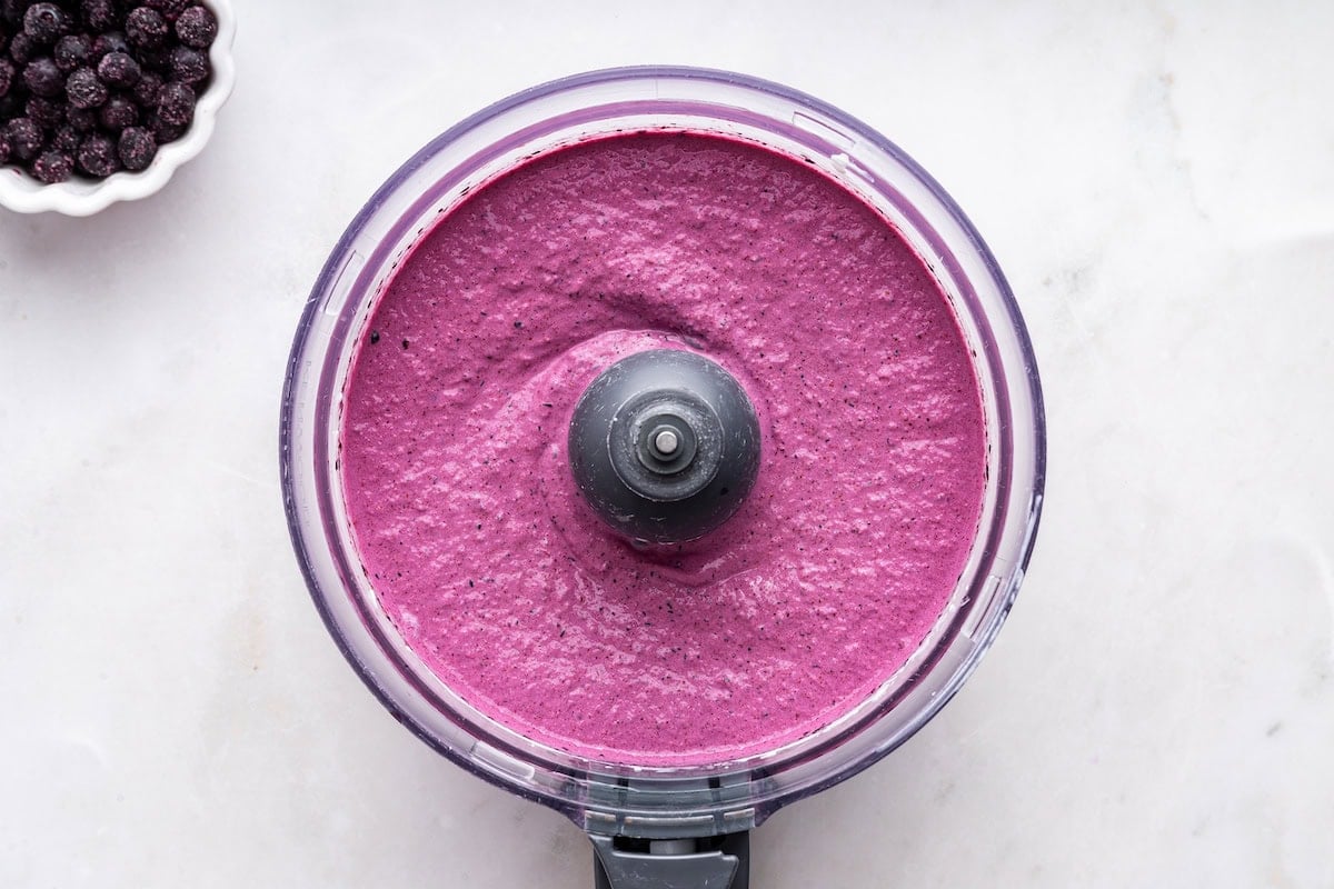 Blueberry frozen yogurt blended in a food processor.