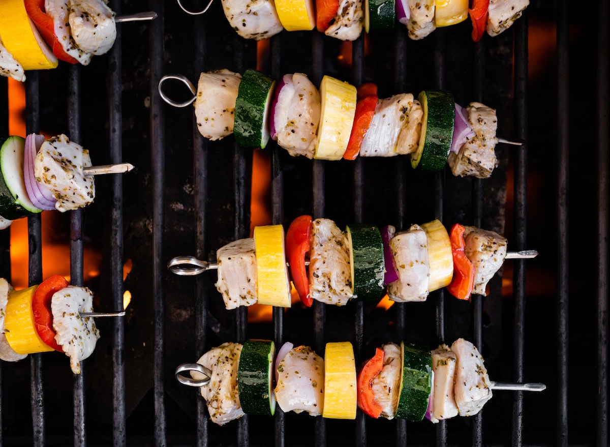 Chicken kabobs on a grill.