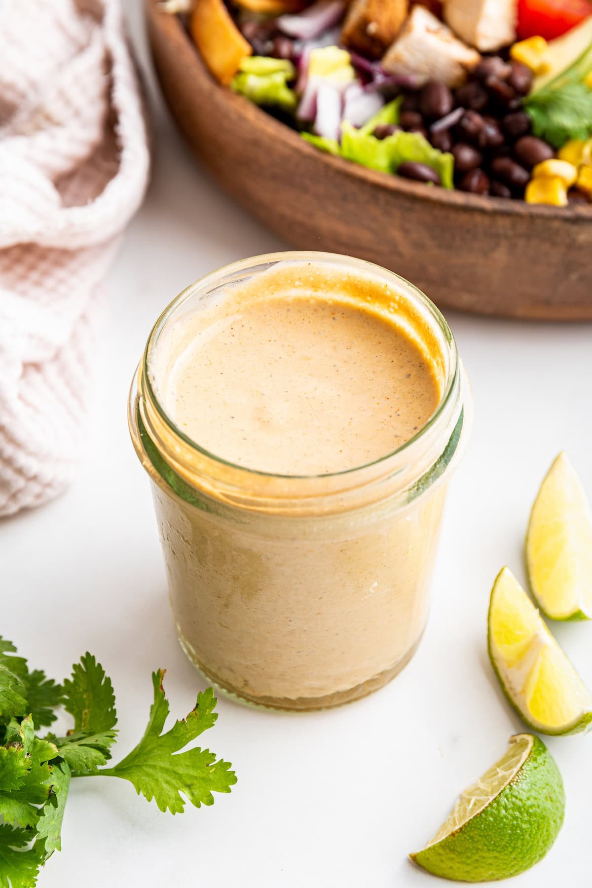 A glass jar filled with the creamy southwest dressing.