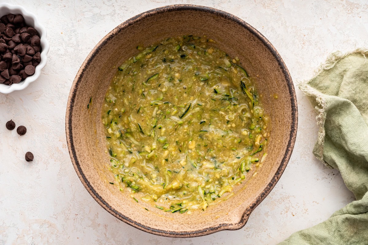Wet ingredients used for vegan zucchini bread in a large mixing bowl.