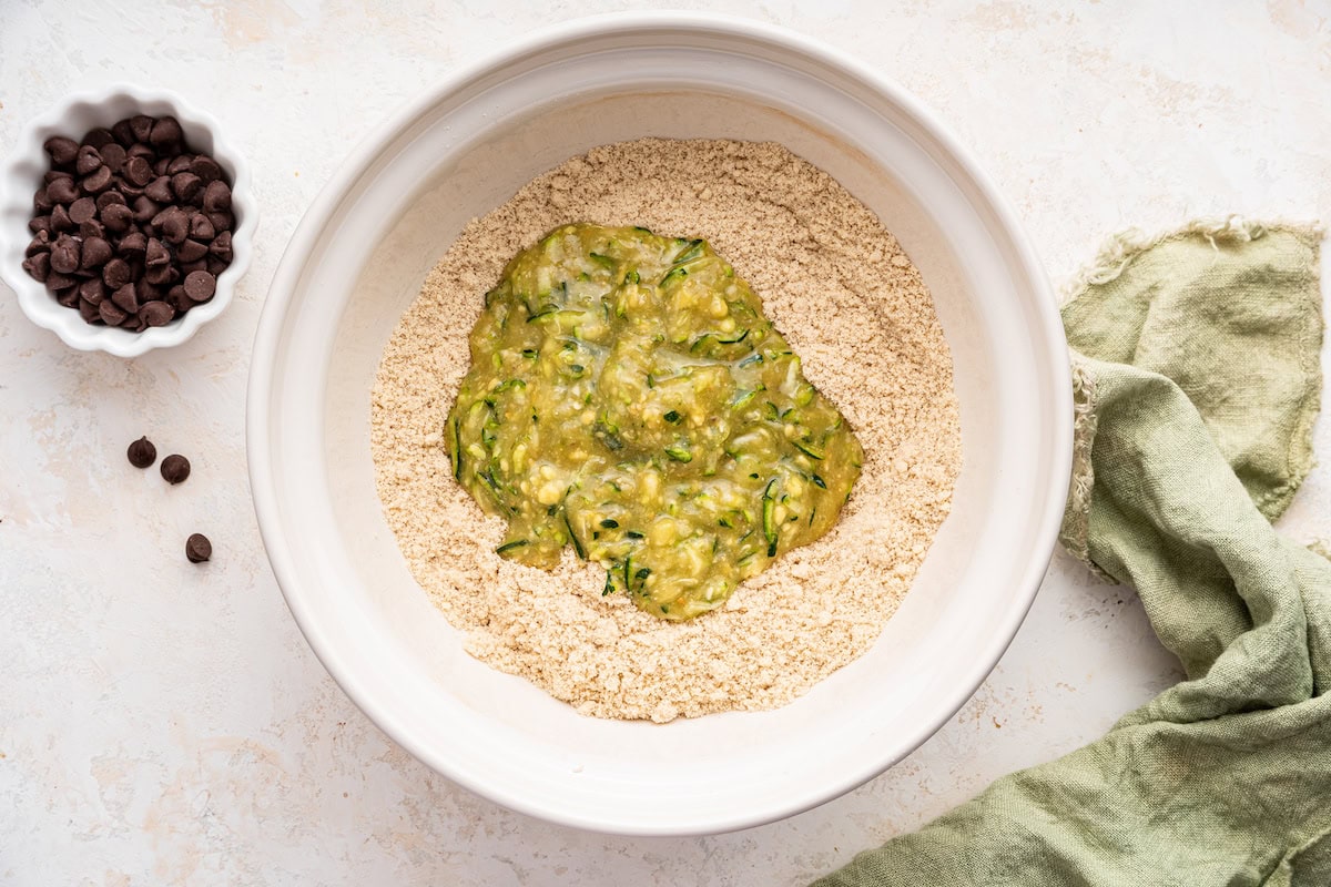 Wet and dry ingredients combined in a large mixing bowl.