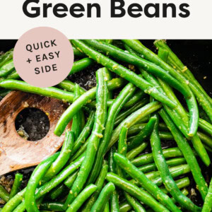 Sautéed Green Beans in a skillet, tossed in olive oil, lemon zest and with a wooden spoon.