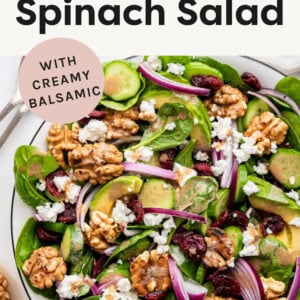 Spinach salad topped with avocado, walnuts, onions, cranberries, cucumber and creamy balsamic.
