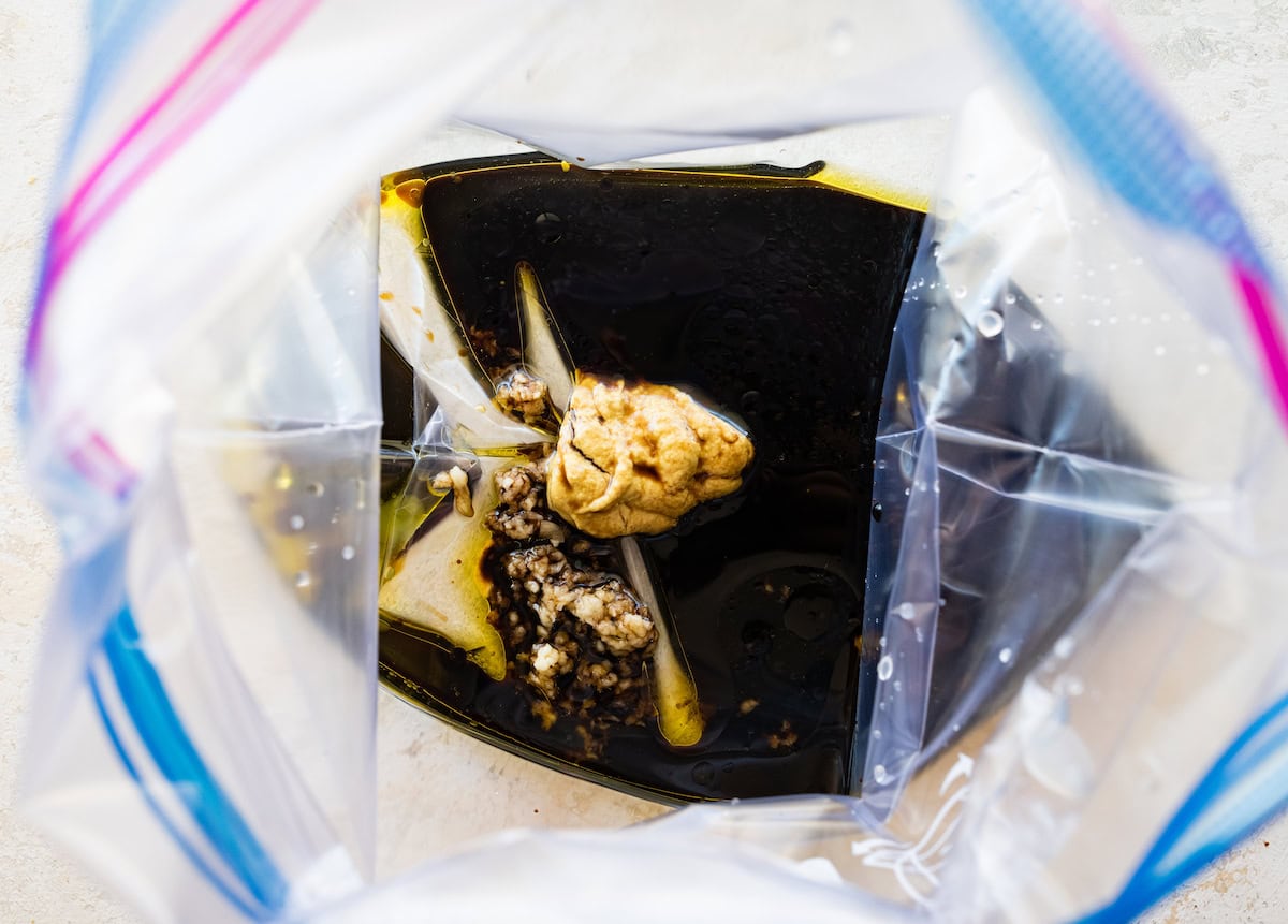 A bag of lemon juice, soy sauce, brown sugar, dijon mustard and garlic that will be used as a marinade.