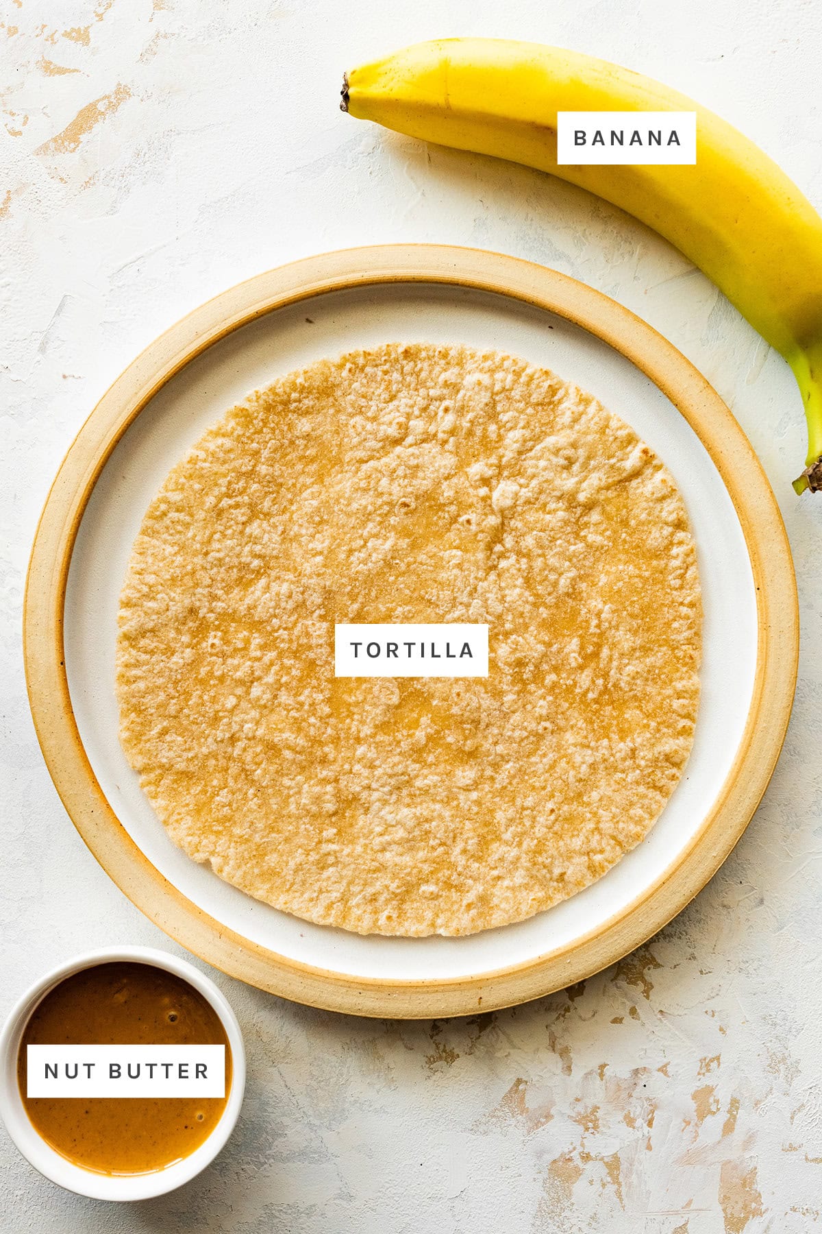 Ingredients measured out to make Banana Sushi Roll Ups: banana, tortilla and nut butter.