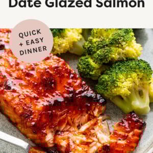Air Fryer Date Glazed Salmon with a bite taken out of it. Served on a plate with broccoli.
