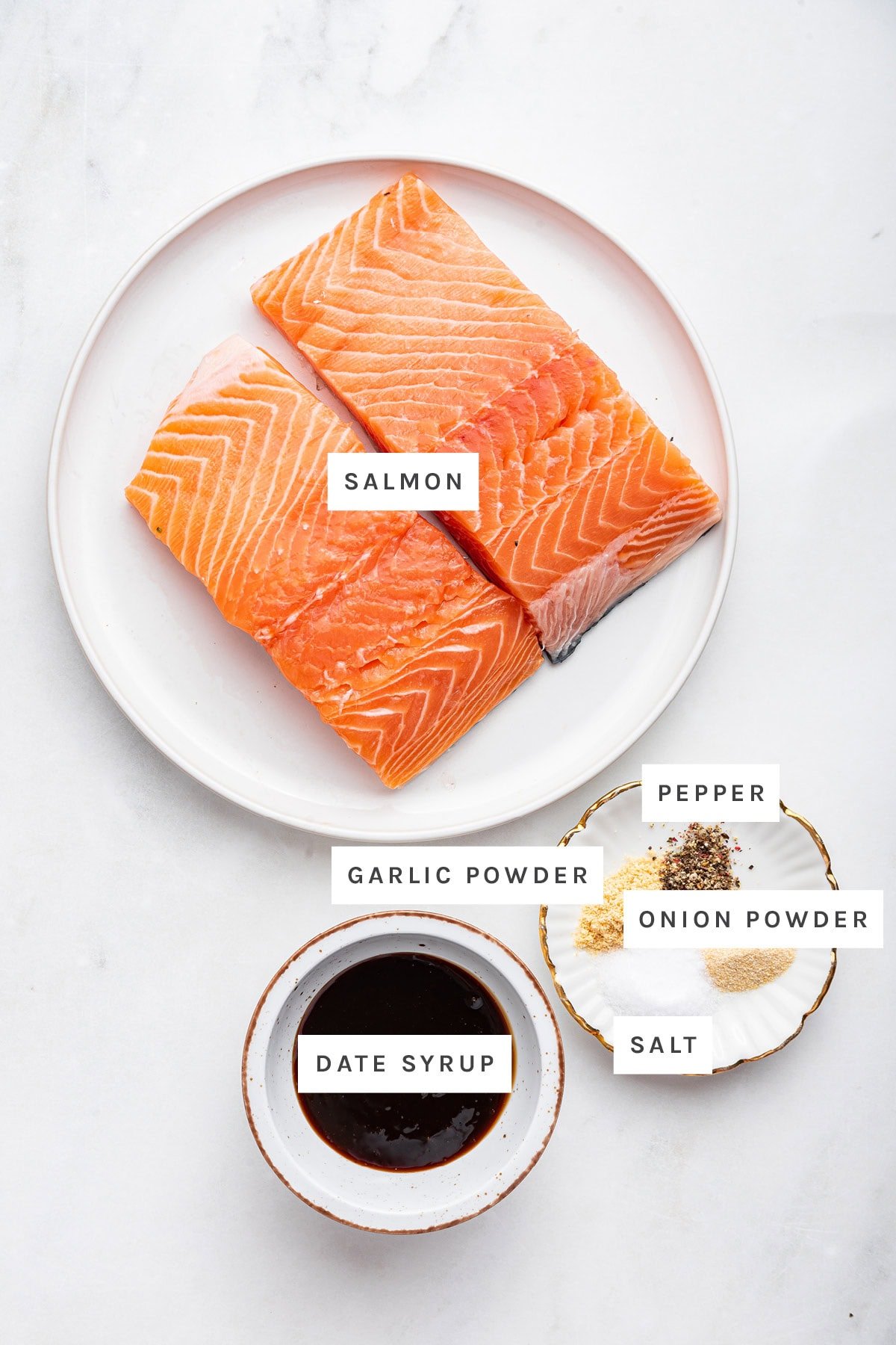 Ingredients measured out to make Air Fryer Date Glazed Salmon: salmon, garlic powder, pepper, onion powder, salt and date syrup.