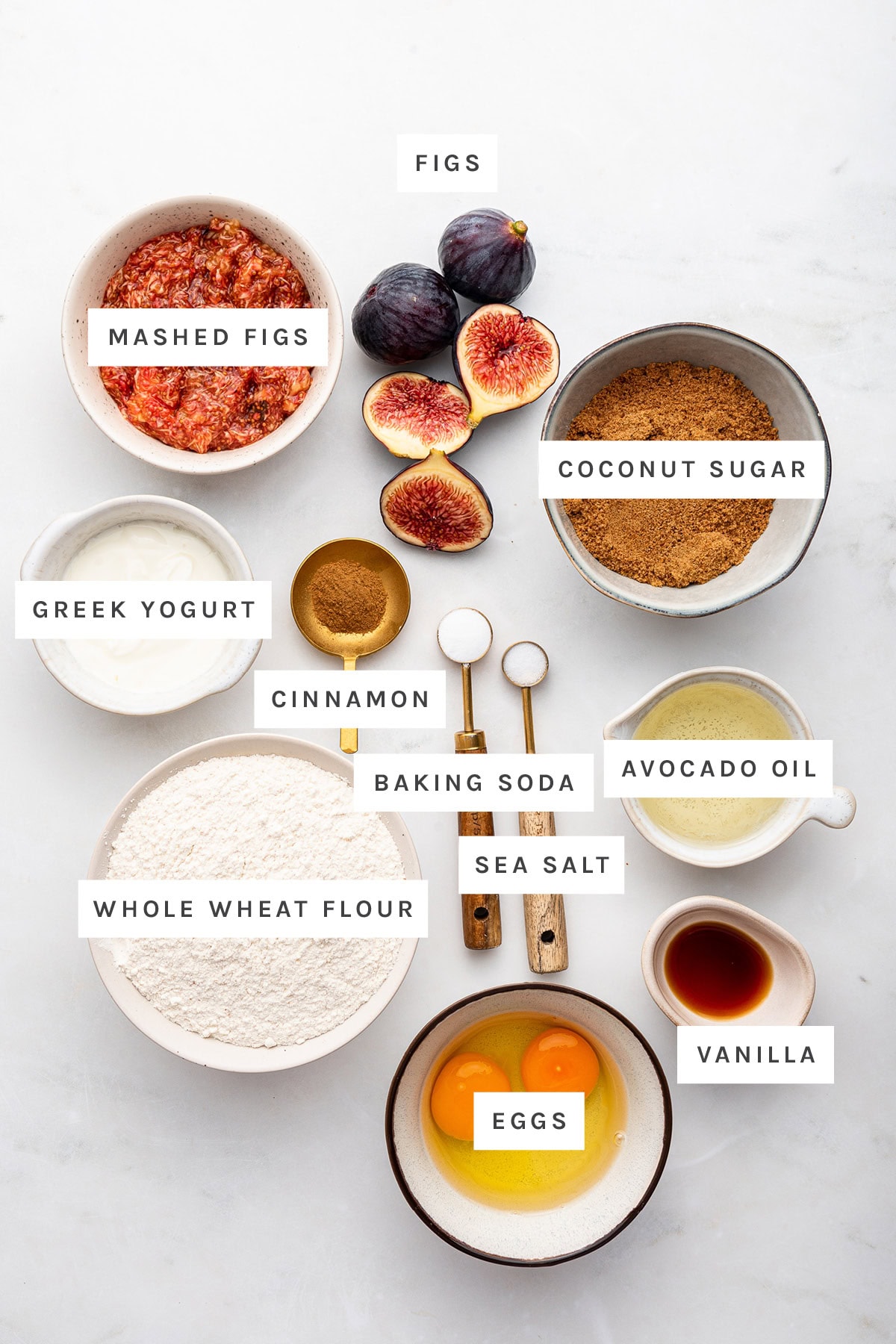 Ingredients measured out to make Healthy Fig Bread: mashed figs, figs, coconut sugar, Greek yogurt, cinnamon, baking soda, avocado oil, sea salt, whole wheat kosher flour, eggs and vanilla.